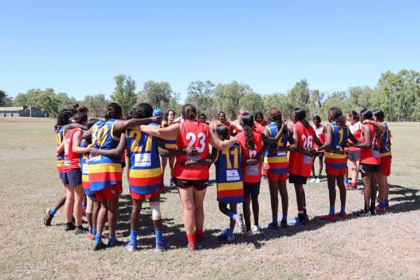 Huddle of two football teams