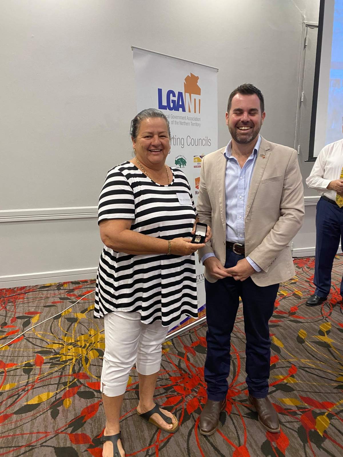 Council's Mayor being presented with her medal by a Minister 