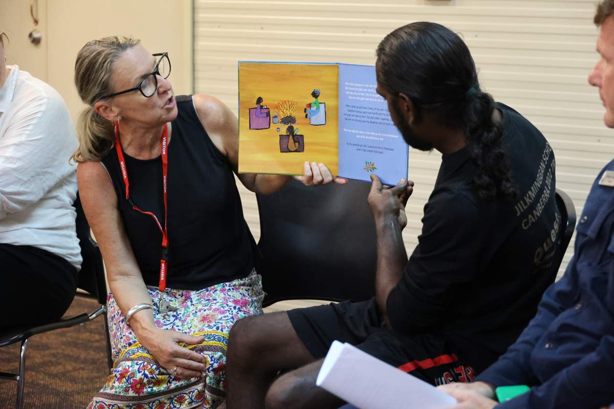 Two people reading from the same book