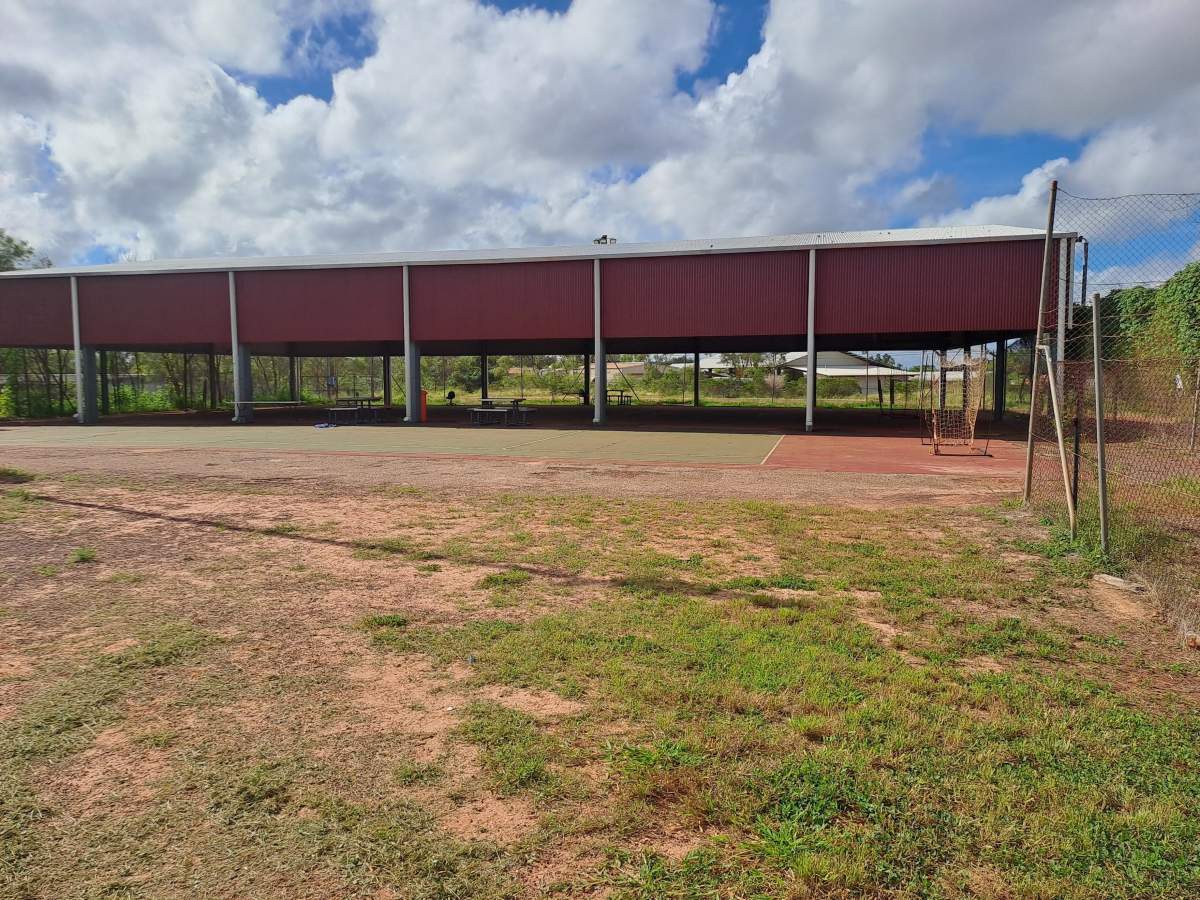 Sheltered Basketball Court with dry grass area at front of image