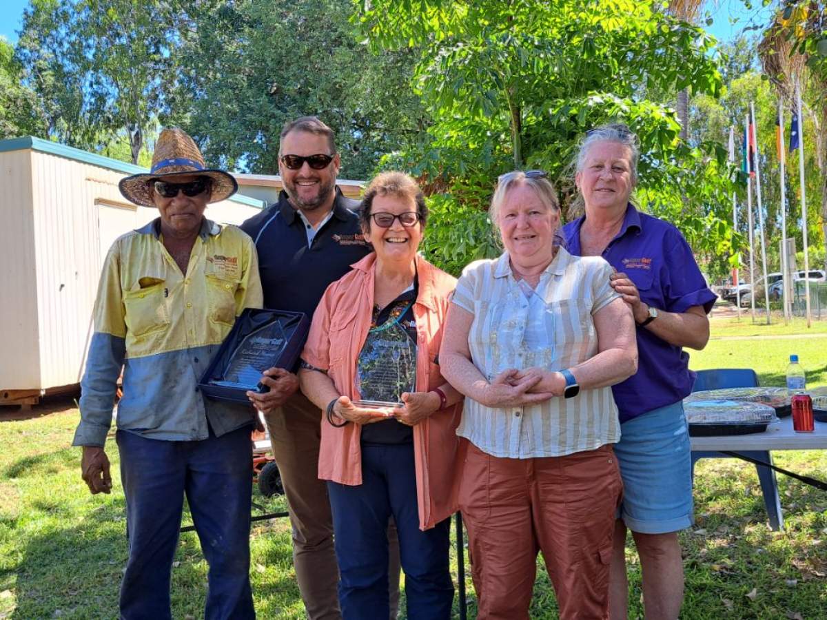Staff members stand together outside 