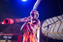 Man playing didgeridoo on stage